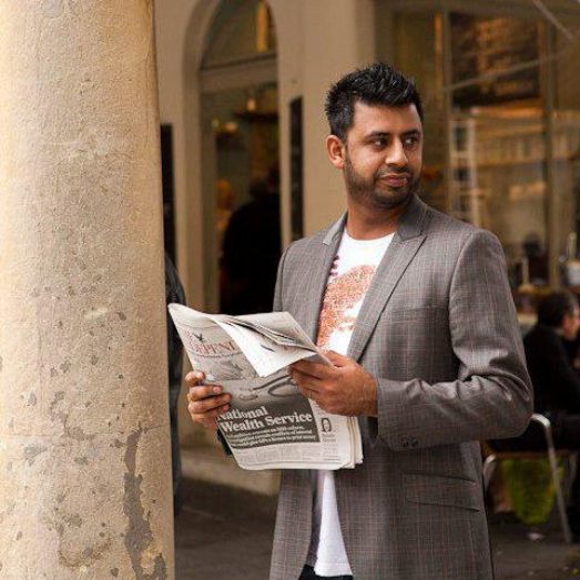 Aman Hayer Holding A Newspaper