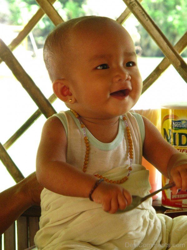 Baby Holding Spoon