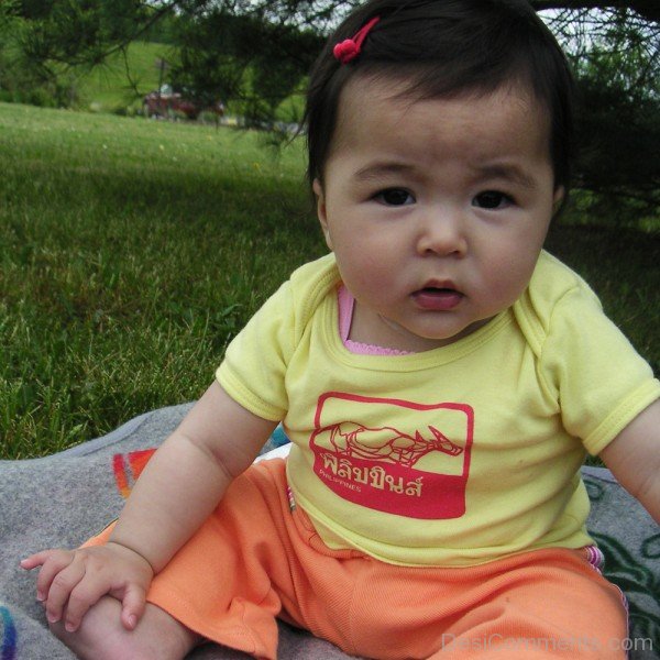 Sweet Baby Girl Sitting On Grass